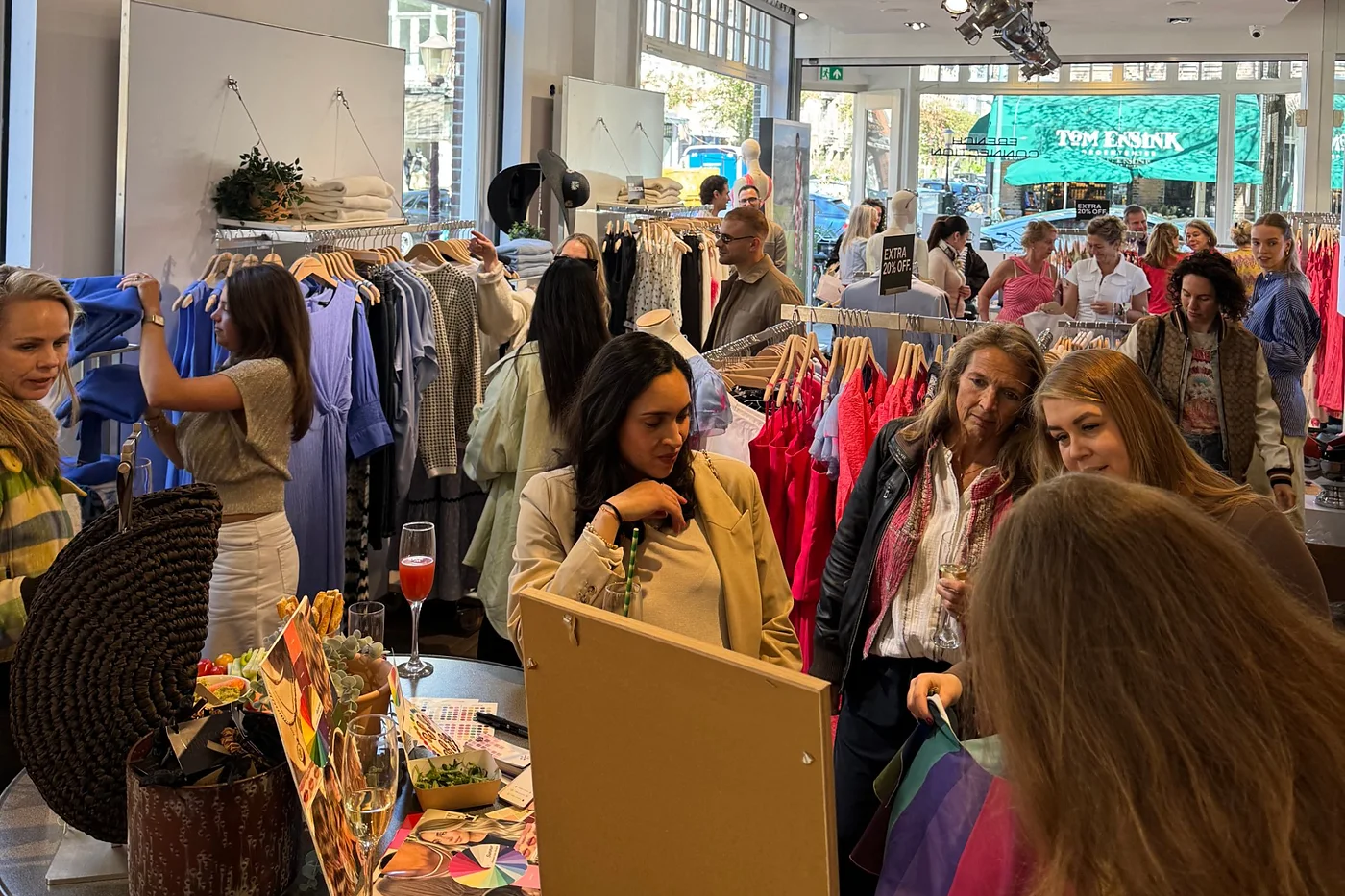 Guests browsing the Spring/Summer 2026 collection at French Connection Amsterdam during the Afternoon of Style, with colour consultation swatches on a table